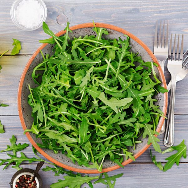 fresh leaves arugula bowl light wooden background flat lay top view 2829 4220