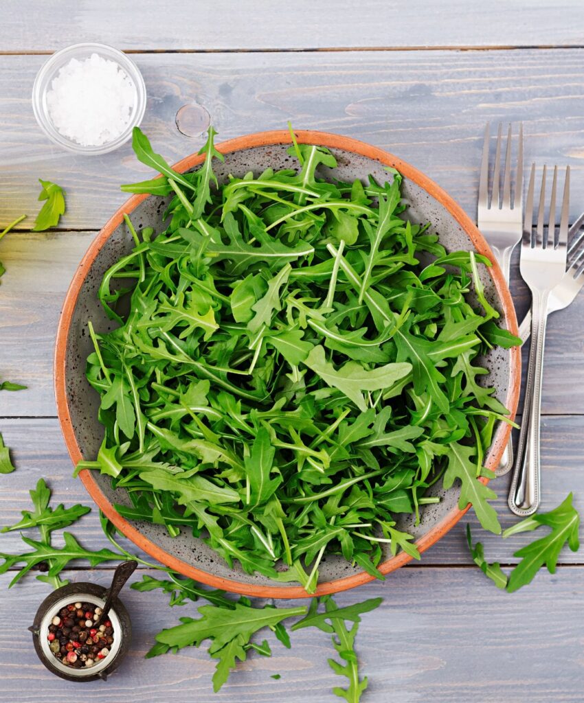 fresh leaves arugula bowl light wooden background flat lay top view 2829 4220
