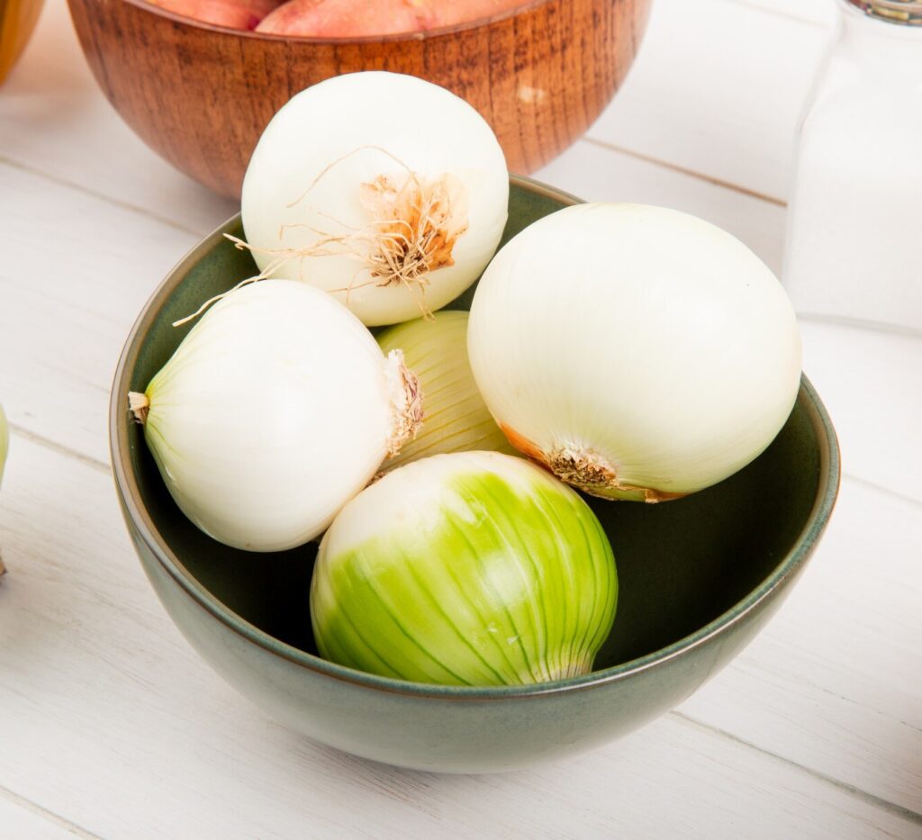 side view white onions bowl with potatoes bowl salt butter around wooden background 141793 9477